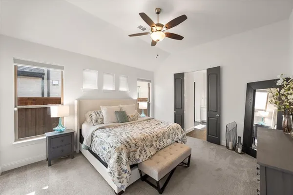 a kitchen with a dining table chairs and refrigerator