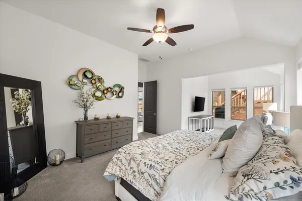 a bedroom with a large bed and a window