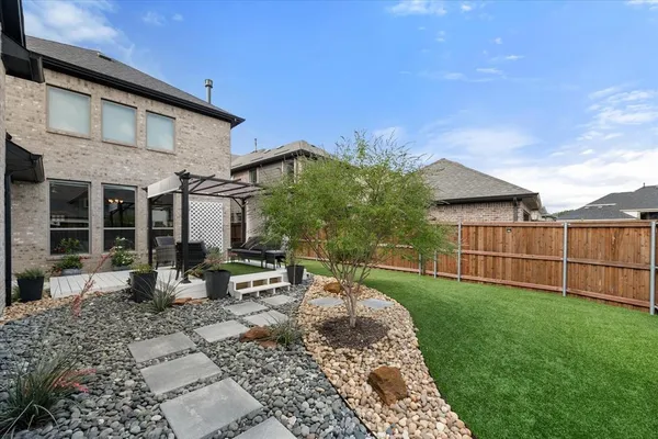 a backyard of a house with table and chairs