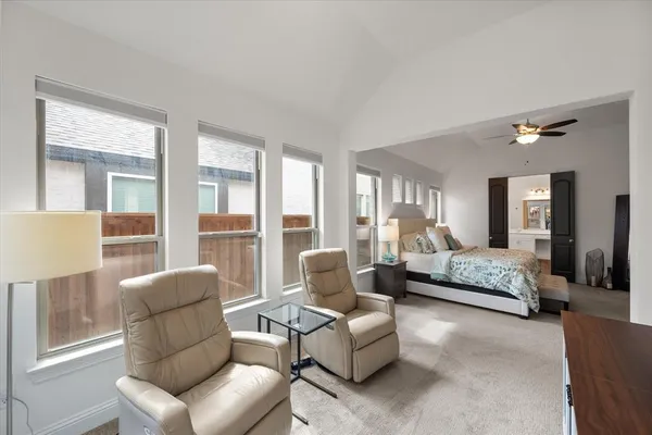 a bedroom with a bed dresser and window