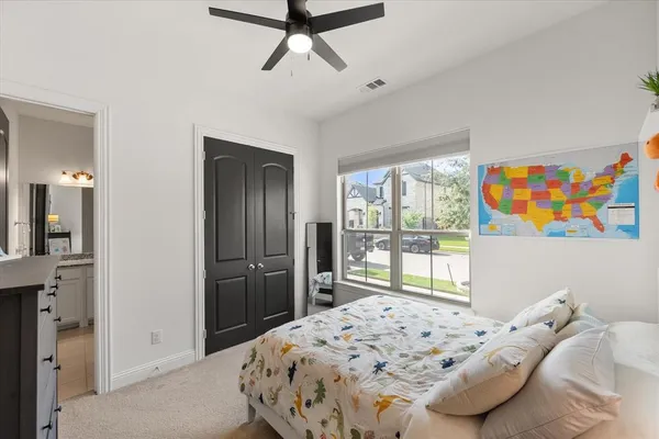 a bedroom with a bed and a large window with the outer view