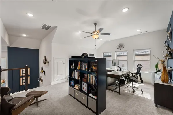 a living room with furniture and a ceiling fan