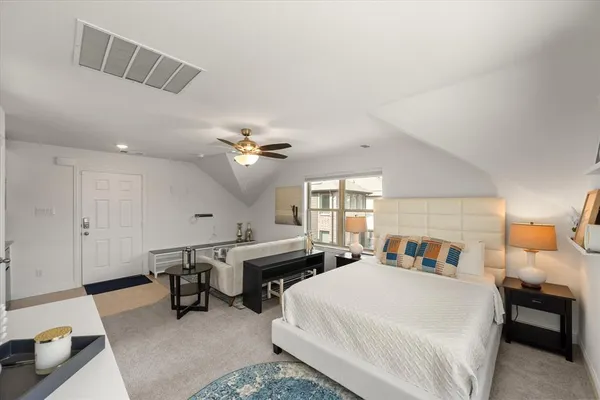 a living room with furniture flat screen tv and window