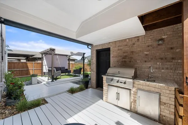 a kitchen with a stove a sink and a wooden floors