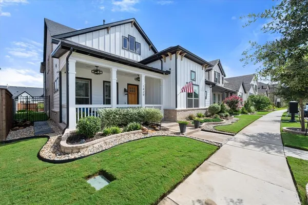 a front view of a house with a yard table and chairs