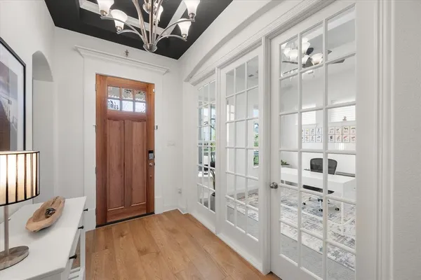 a bedroom with a large bed and a chandelier