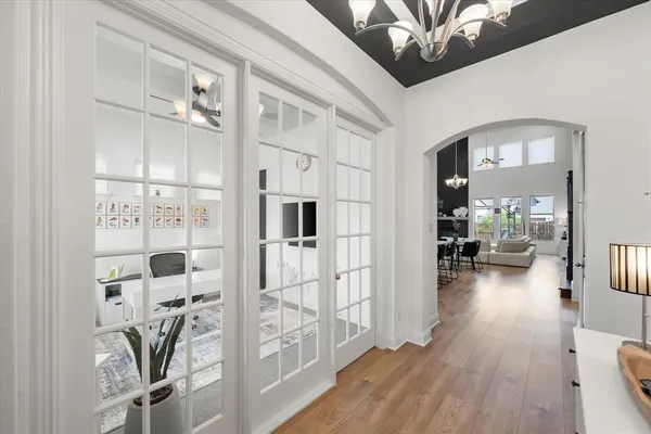 a living room with furniture a flat screen tv and a floor to ceiling window