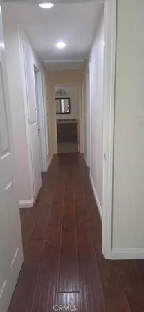a view of hallway with wooden floor