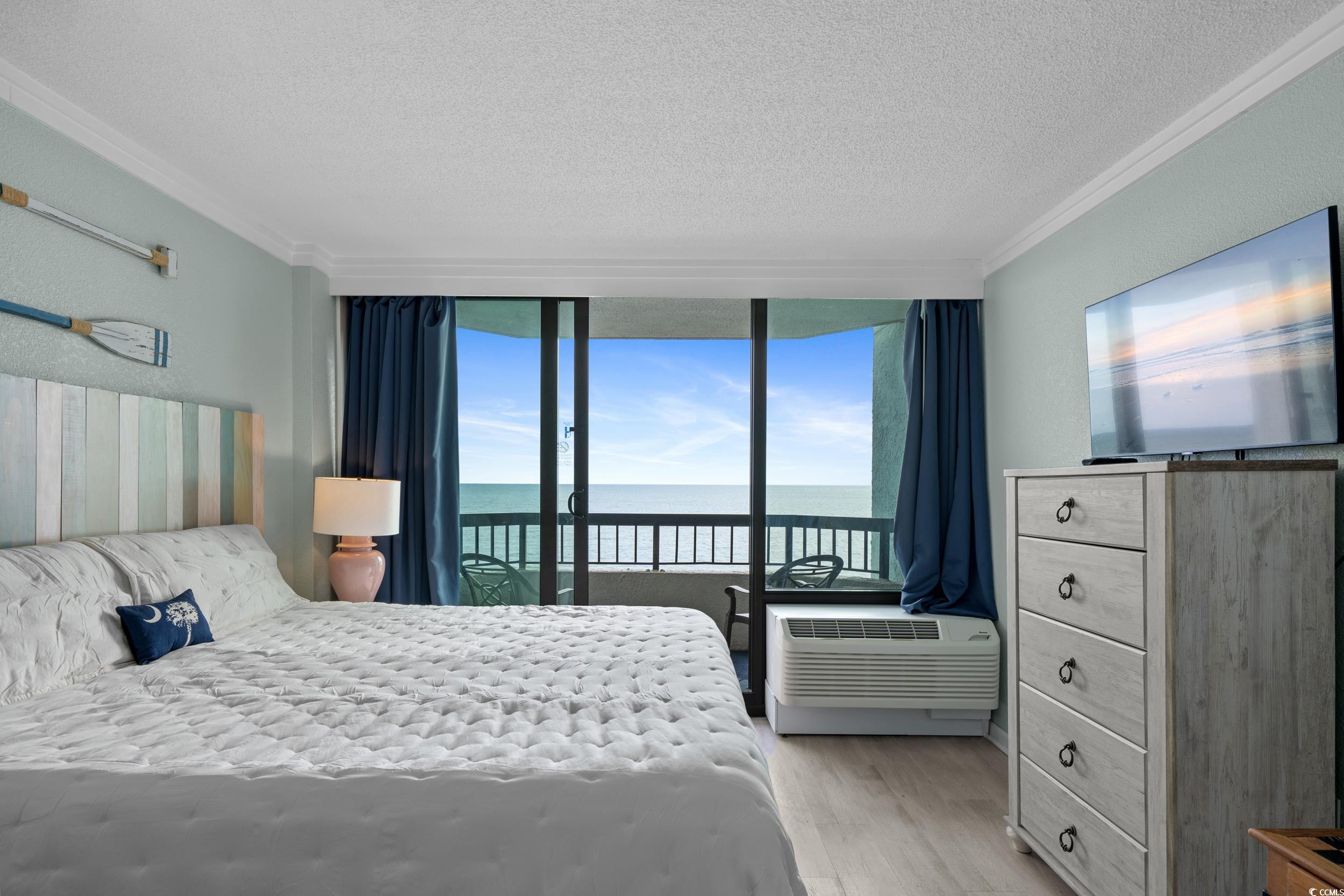 2401 South Ocean Boulevard, Unit 659 Myrtle Beach, SC 29577 - Photo 23 of 38 Bedroom featuring a textured ceiling, light wood finished floors, access to exterior, and crown molding