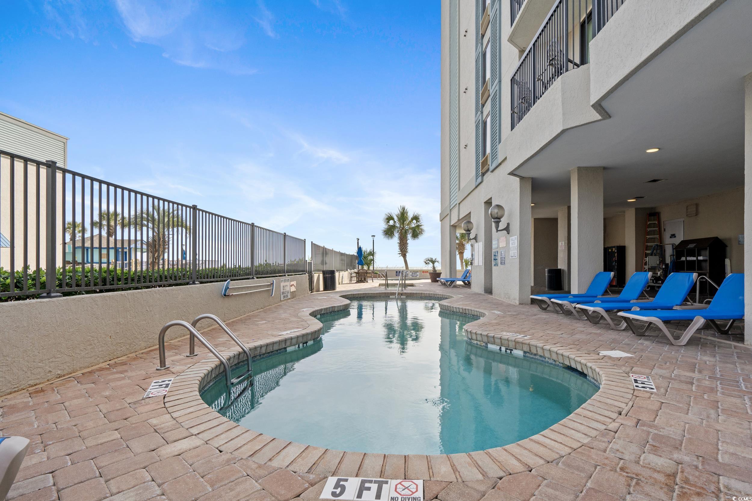 2401 South Ocean Boulevard, Unit 659 Myrtle Beach, SC 29577 - Photo 31 of 38 Community pool with a patio area