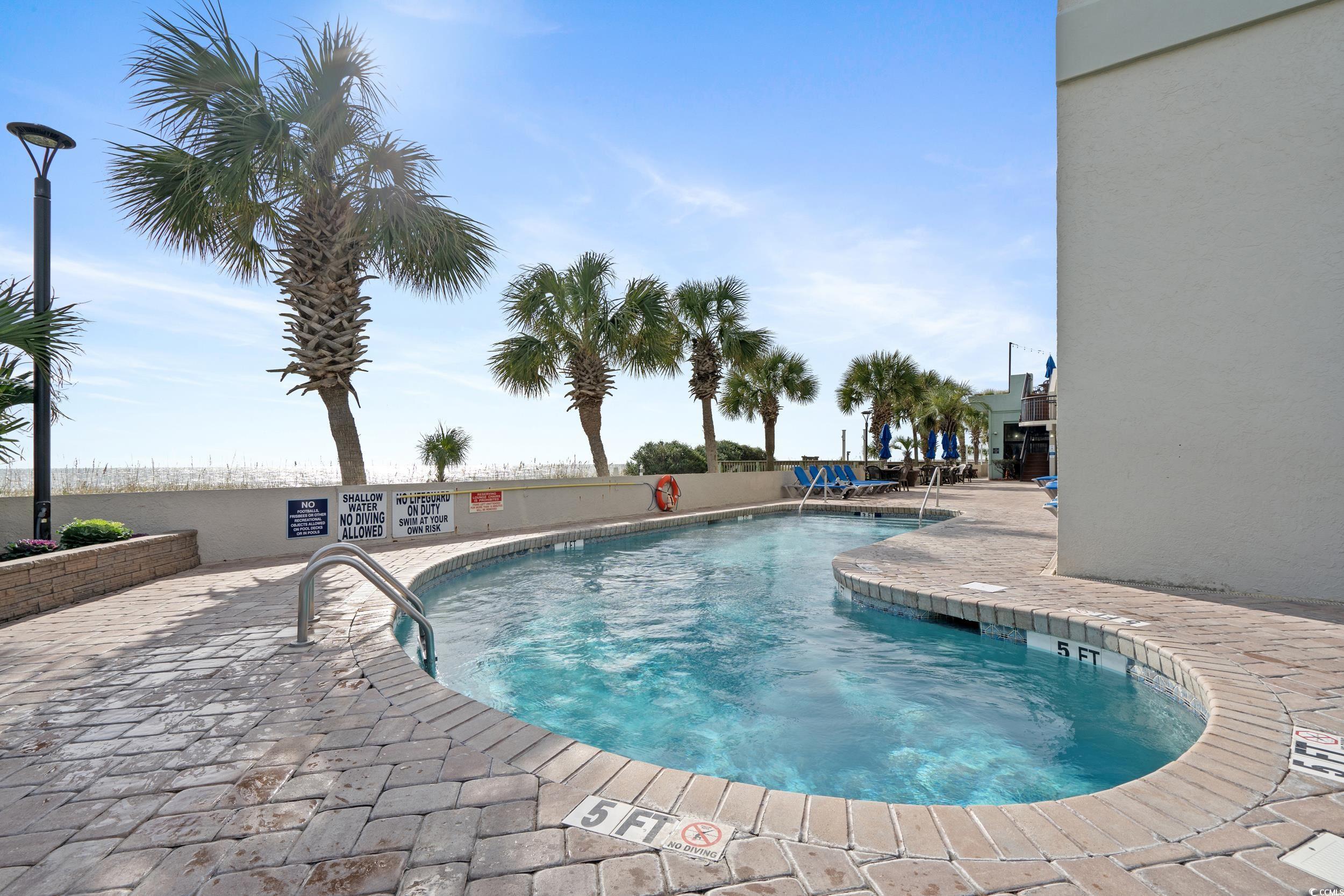2401 South Ocean Boulevard, Unit 659 Myrtle Beach, SC 29577 - Photo 32 of 38 Community pool featuring a patio area