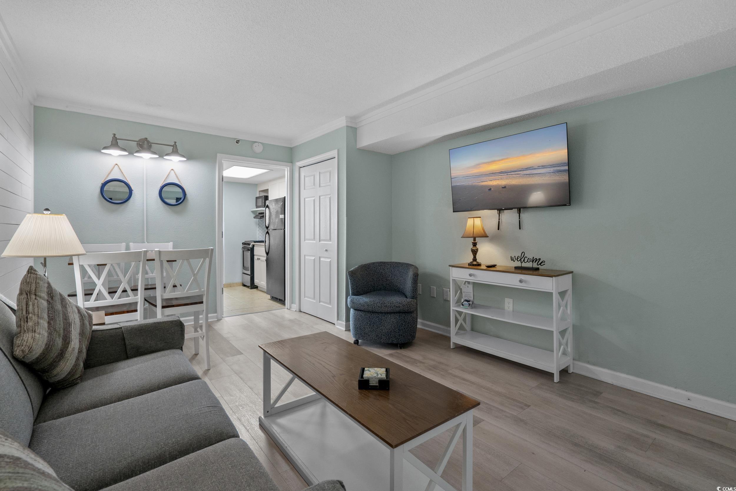 2401 South Ocean Boulevard, Unit 659 Myrtle Beach, SC 29577 - Photo 7 of 38 Living area with crown molding and light wood finished floors
