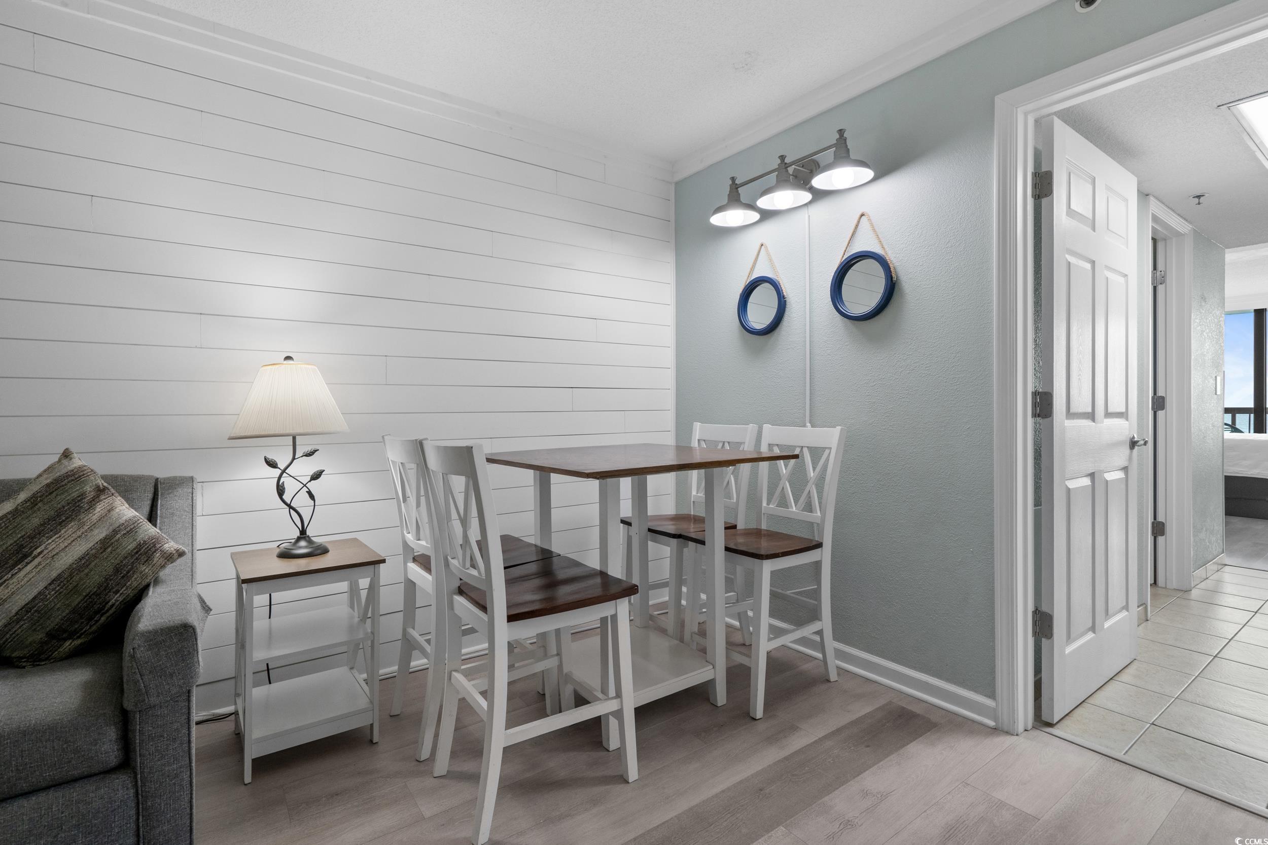 2401 South Ocean Boulevard, Unit 659 Myrtle Beach, SC 29577 - Photo 9 of 38 Dining space featuring light wood-type flooring and a textured wall