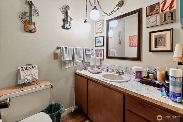 a bathroom with a sink mirror vanity and toilet