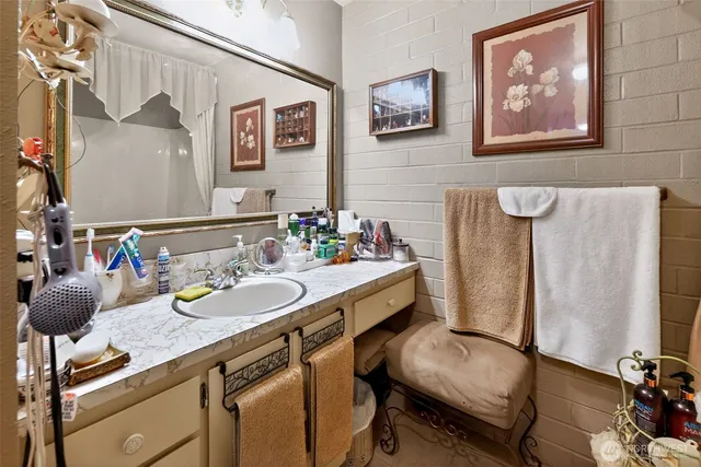 a bathroom with a sink mirror and vanity