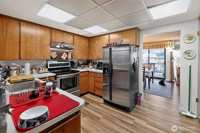 a kitchen with stainless steel appliances granite countertop a refrigerator stove and sink