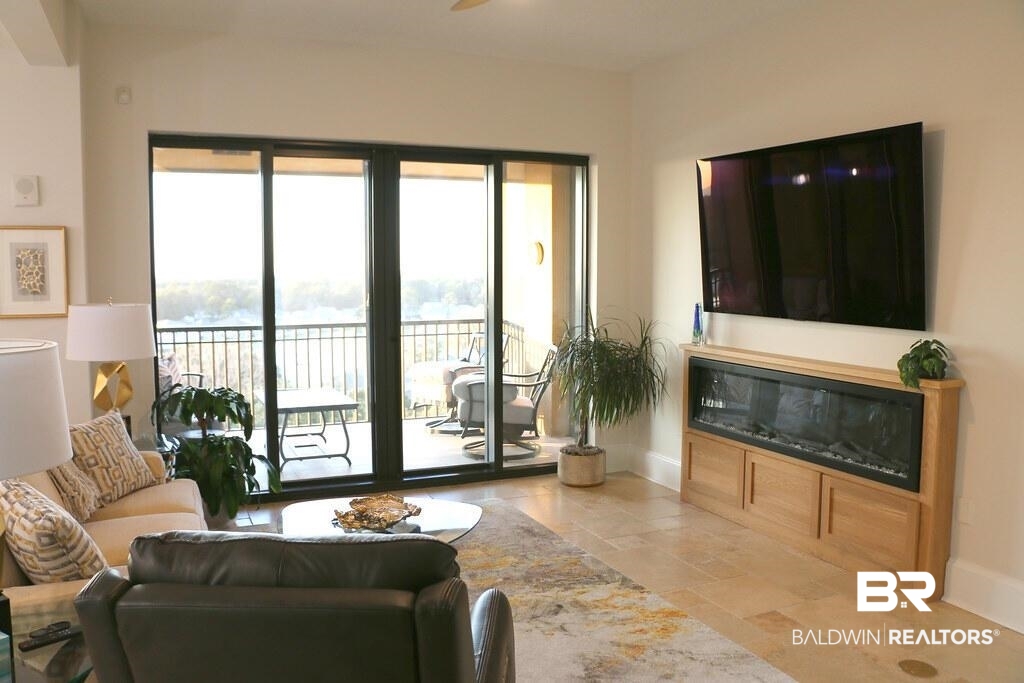 18269 Colony Drive, Unit 803 Fairhope, AL 36532 - Photo 2 of 27 Living area with stone tile floors and a ceiling fan