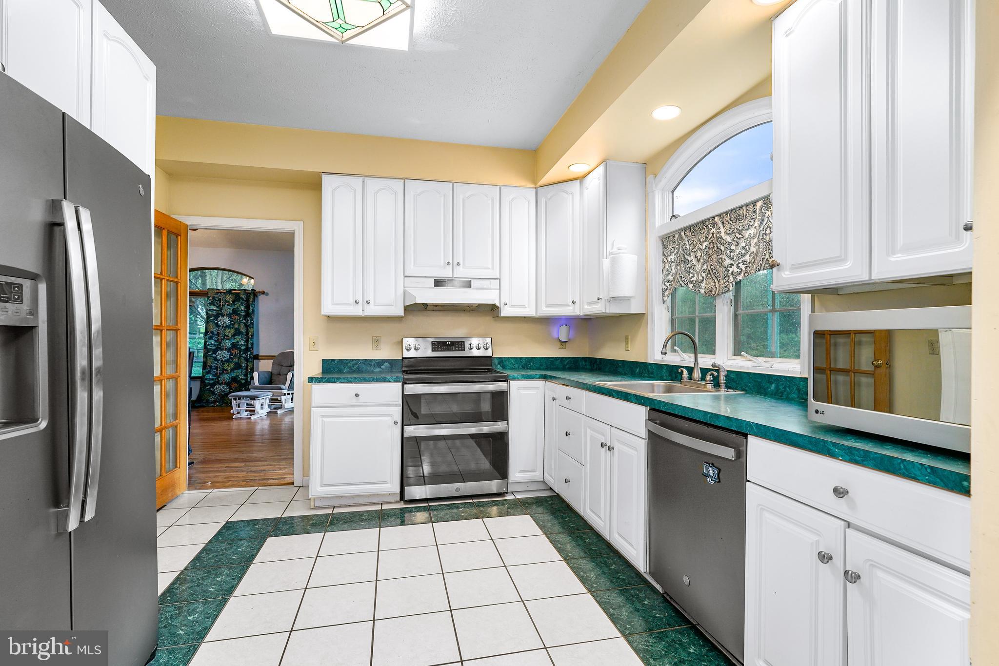 177 Pearce Creek Drive Earleville, MD 21919 - Photo 13 of 37 a kitchen with a sink a refrigerator and cabinets