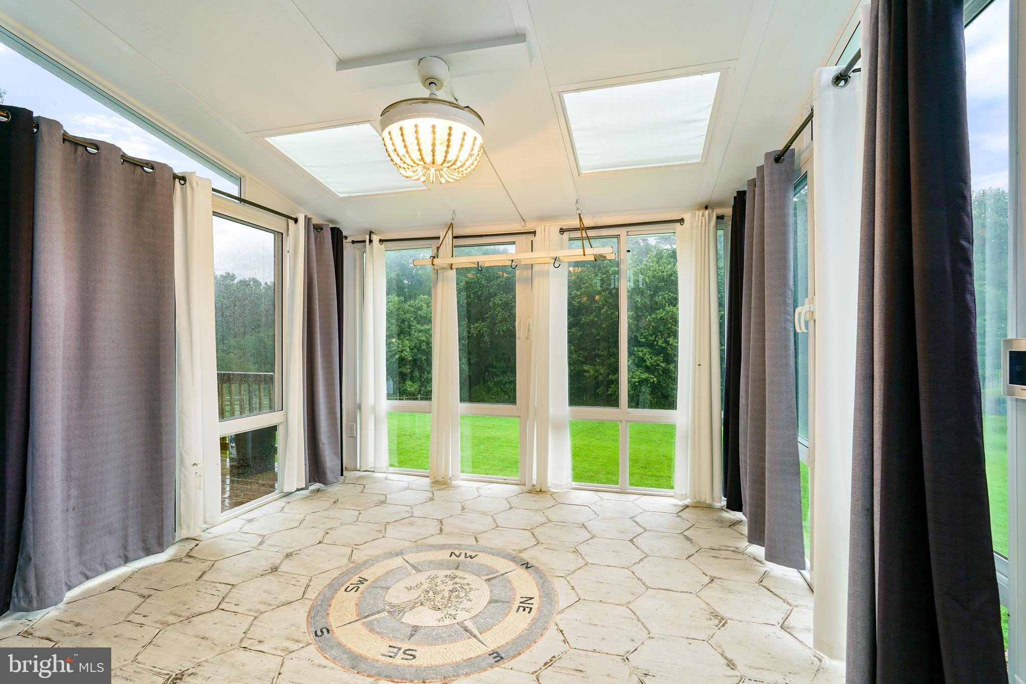 177 Pearce Creek Drive Earleville, MD 21919 - Photo 17 of 37 a view of empty room with window and chandelier