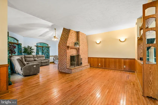a living room with furniture garden view and large windows