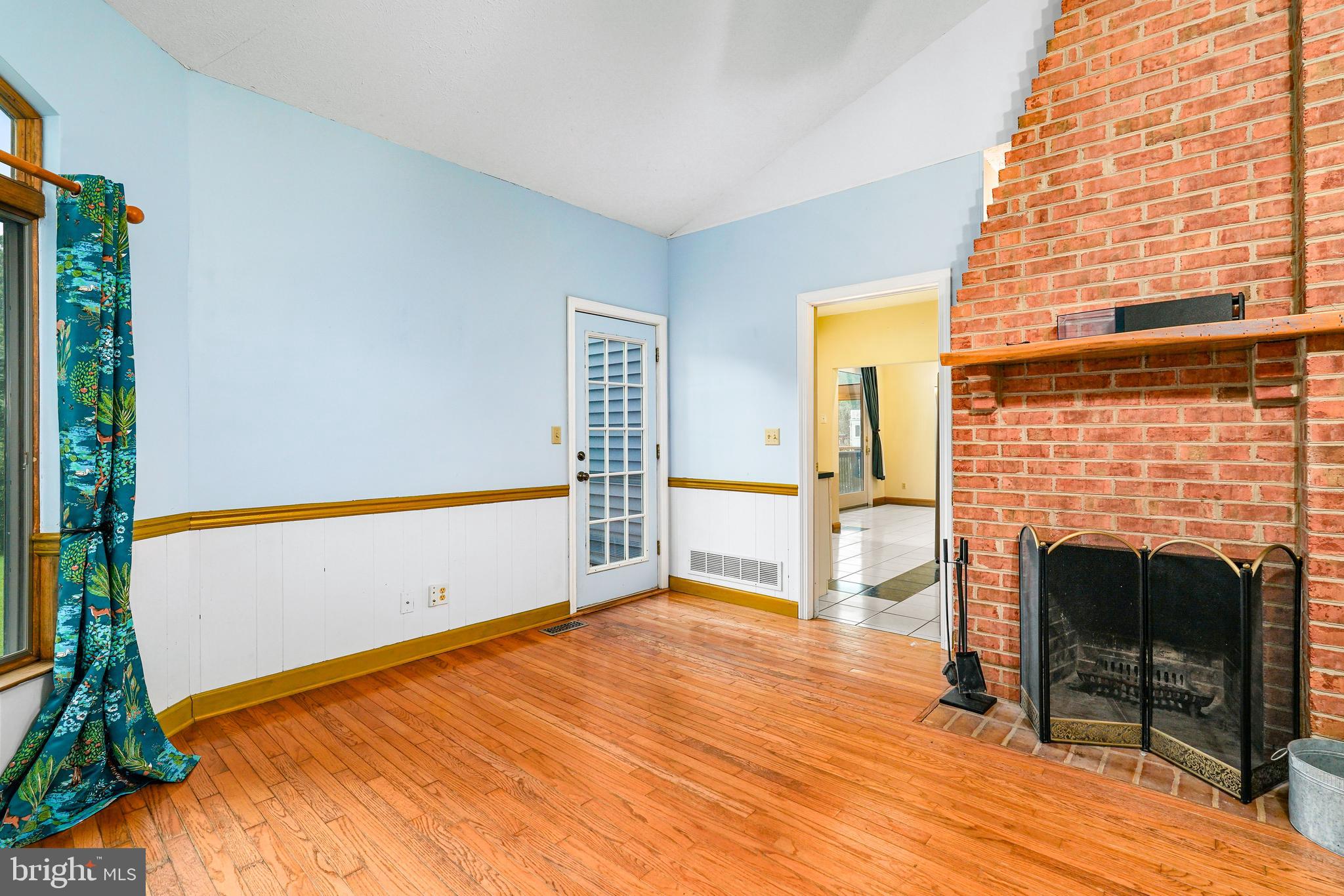 177 Pearce Creek Drive Earleville, MD 21919 - Photo 7 of 37 a living room with a fireplace and a floor to ceiling window