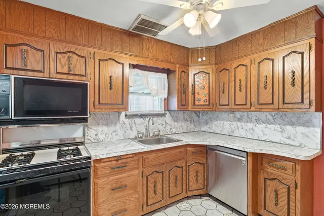 a kitchen with stainless steel appliances granite countertop a sink and cabinets