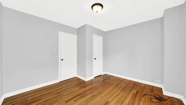 a view of a room with wooden floor and white walls