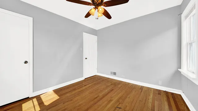 a view of room with window and wooden floor