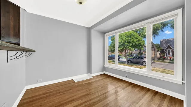 a view of room with window and wooden floor