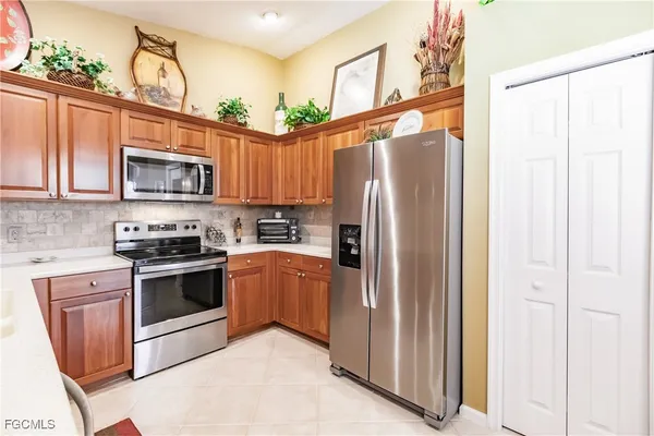 a kitchen with stainless steel appliances granite countertop a refrigerator stove and sink