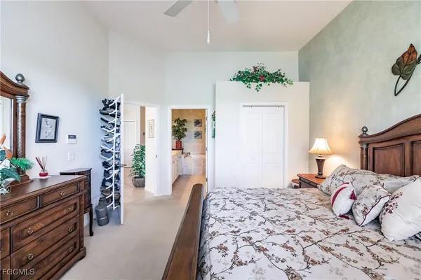 a bedroom with a bed and a potted plant