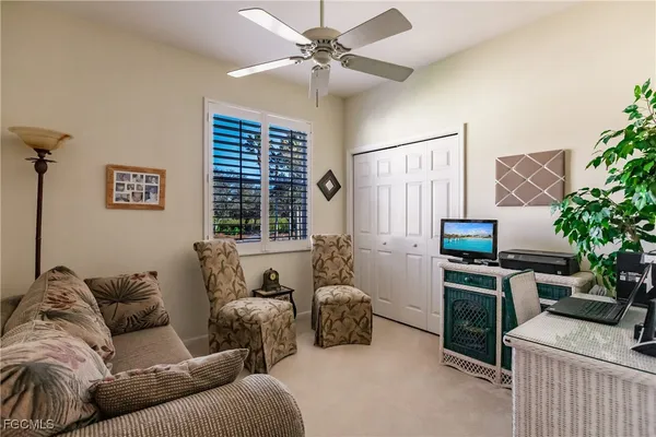 a living room with furniture a chandelier and a window
