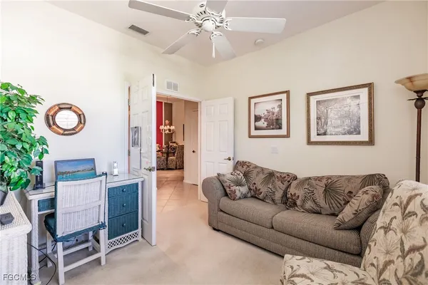a living room with furniture and paintings on the wall