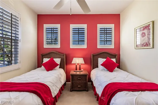 a bedroom with two beds and a window