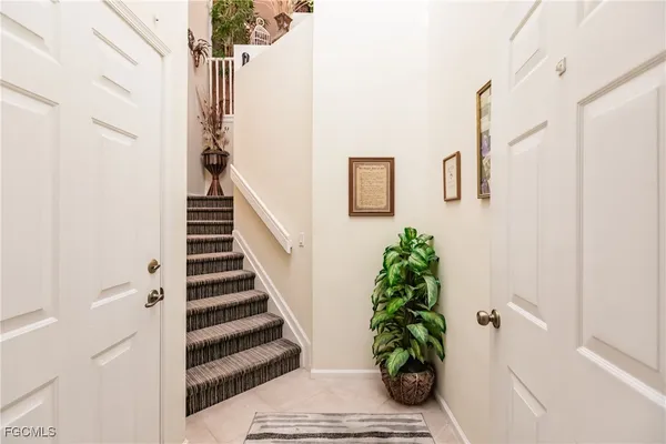 a view of a hallway with wooden floor and stairs
