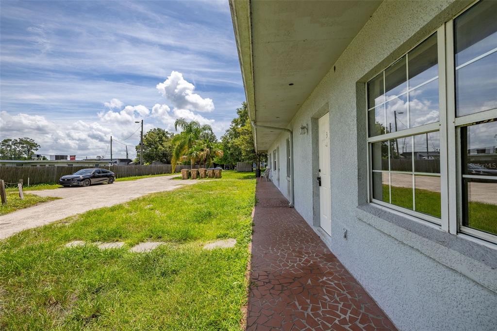 2150 Barbara Drive, Unit 2 St. Cloud, FL 34771 - Photo 2 of 9 a view of a garden with a building in the background