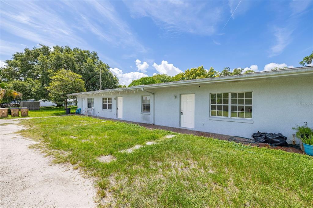 2150 Barbara Drive, Unit 2 St. Cloud, FL 34771 - Photo 4 of 9 a front view of house with yard and trees in the background