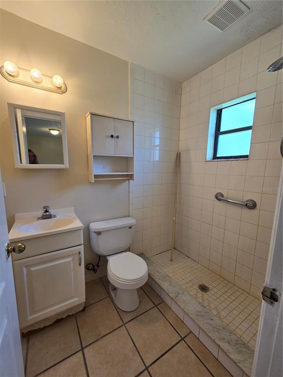 2150 Barbara Drive, Unit 2 St. Cloud, FL 34771 - Photo 8 of 9 a bathroom with a toilet sink and mirror