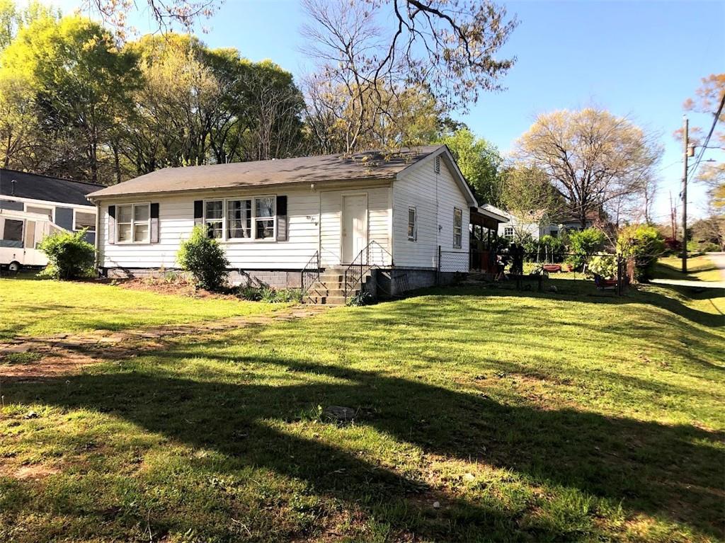 55 Cochran Road Southeast Marietta, GA 30060 - Photo 5 of 20 a view of a house with a big yard and large trees