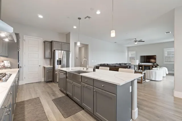 a large kitchen with a large counter top appliances and cabinets