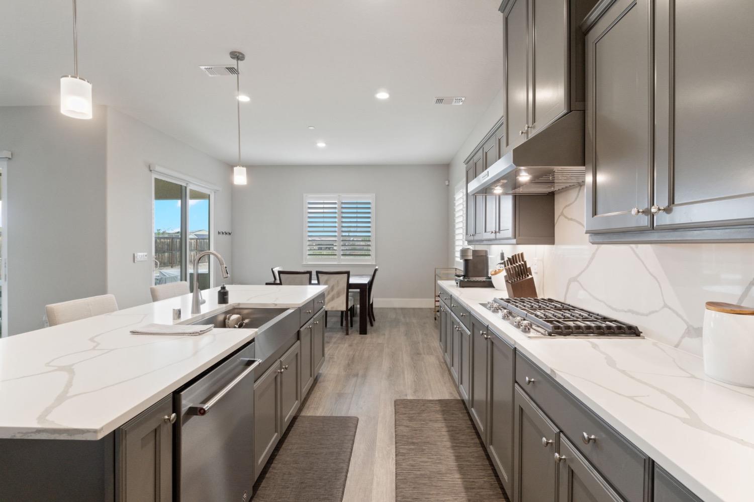 4491 Vineyard Drive Madera, CA 93636 - Photo 13 of 47 a kitchen with sink stove and cabinets