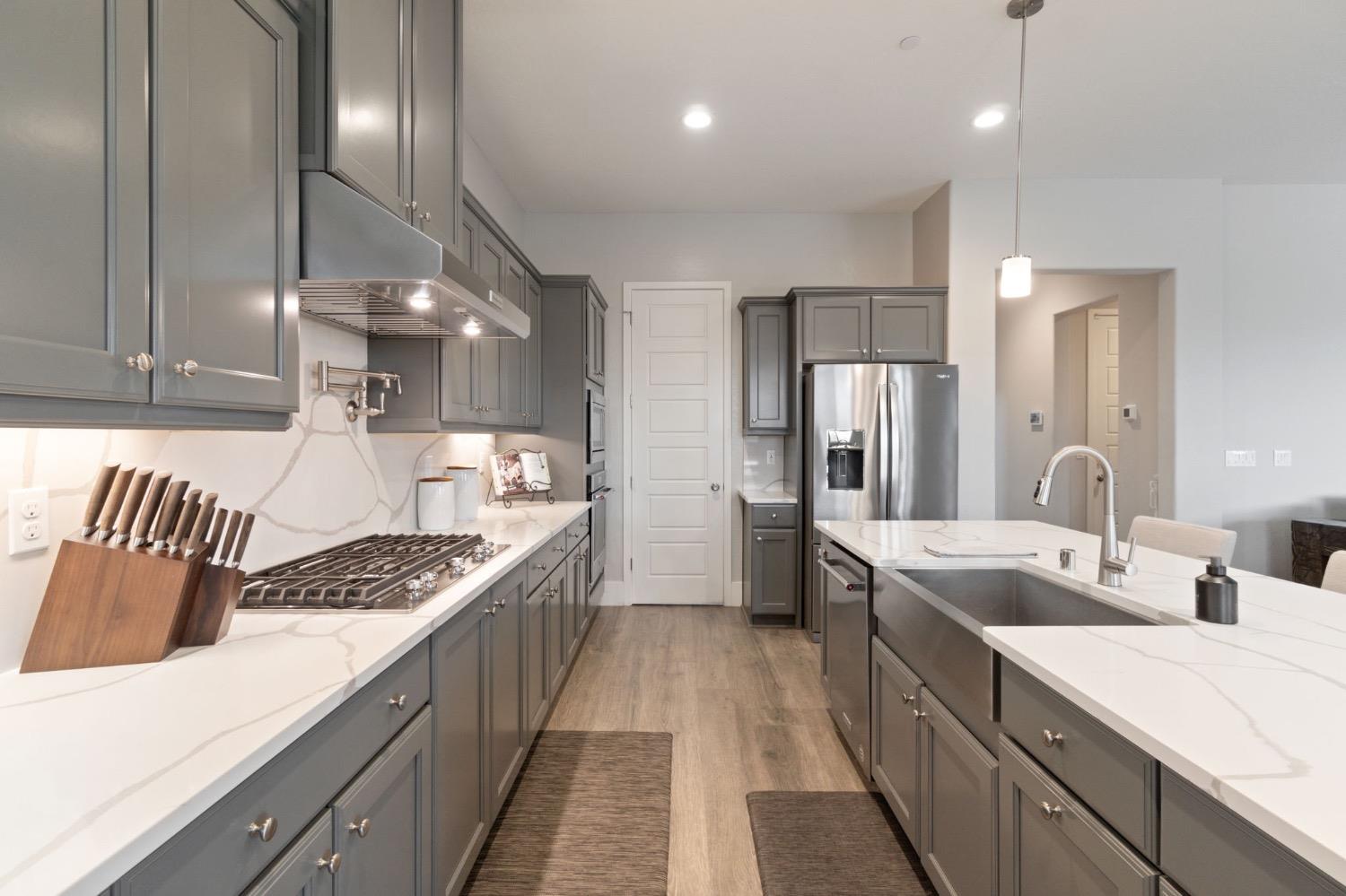 4491 Vineyard Drive Madera, CA 93636 - Photo 14 of 47 a large kitchen with a sink and cabinets