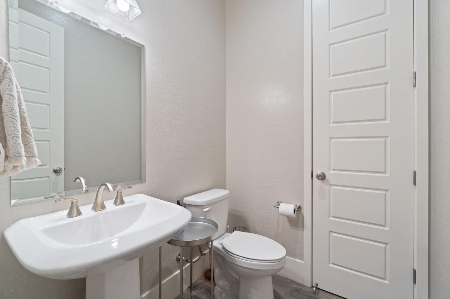 4491 Vineyard Drive Madera, CA 93636 - Photo 20 of 47 a bathroom with a sink a toilet and a mirror
