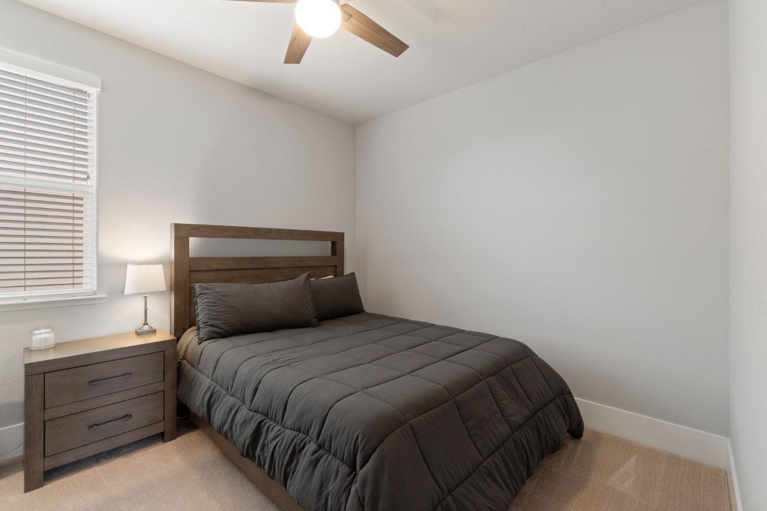 4491 Vineyard Drive Madera, CA 93636 - Photo 25 of 47 a bedroom with a bed and a window