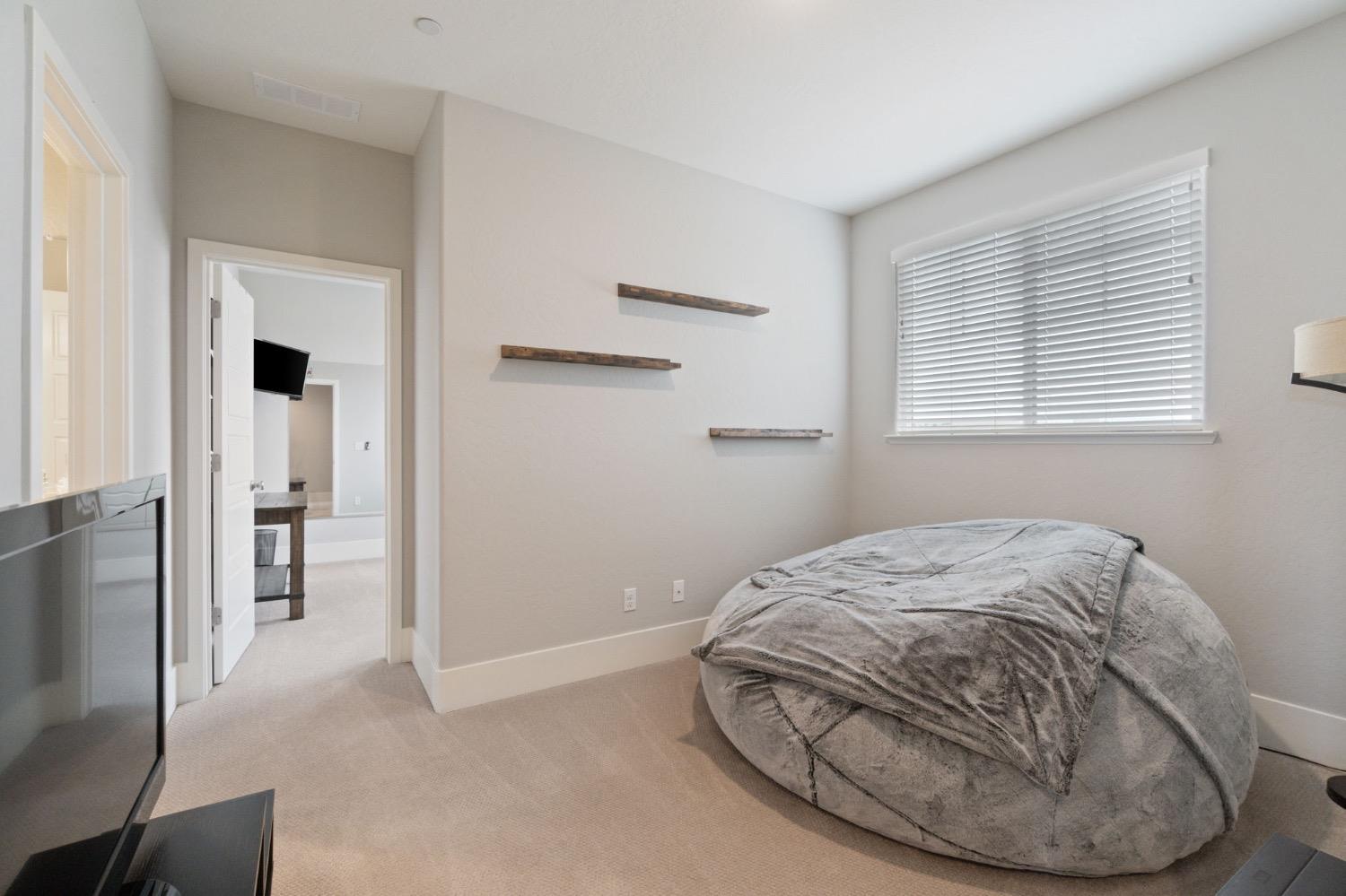 4491 Vineyard Drive Madera, CA 93636 - Photo 29 of 47 a room with a bed and a painting on the wall