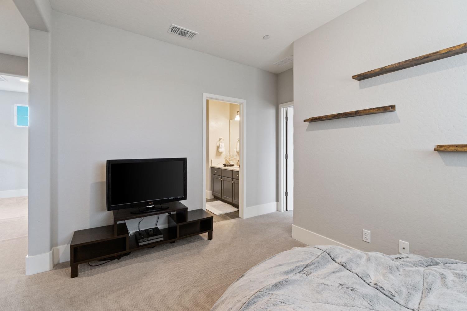 4491 Vineyard Drive Madera, CA 93636 - Photo 30 of 47 a bedroom with a bed and a flat screen tv