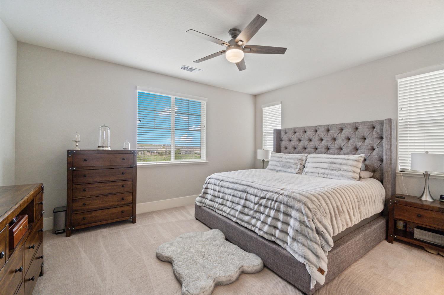 4491 Vineyard Drive Madera, CA 93636 - Photo 32 of 47 a bedroom with a bed a dresser and a window