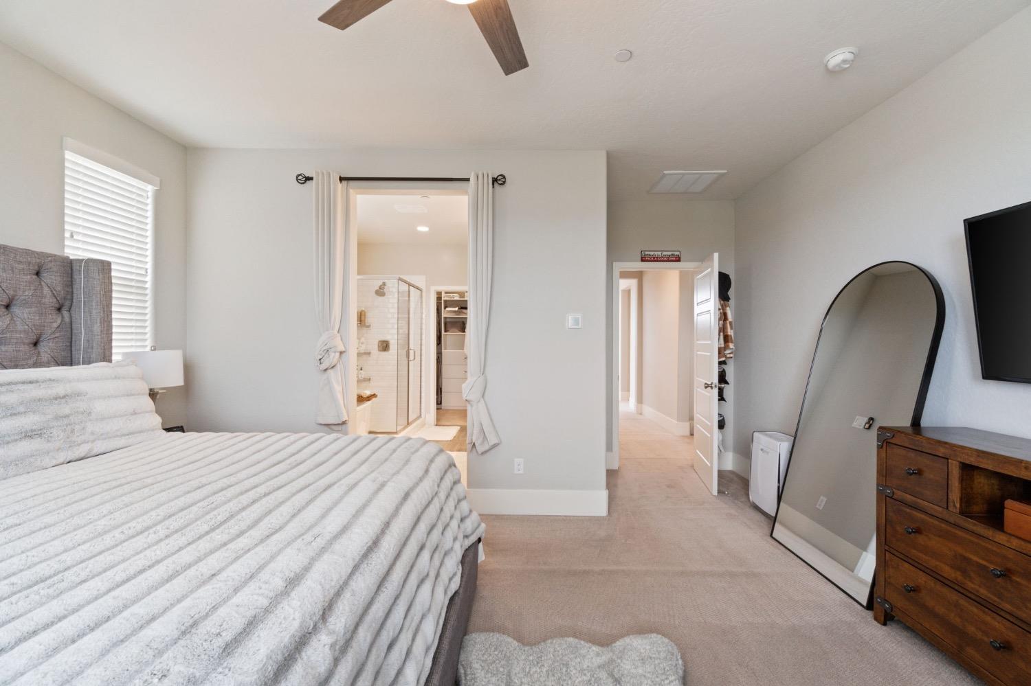 4491 Vineyard Drive Madera, CA 93636 - Photo 33 of 47 a bedroom with a bed and a large mirror on the dresser