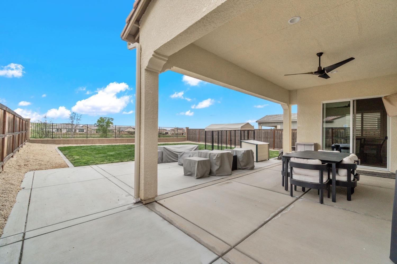 4491 Vineyard Drive Madera, CA 93636 - Photo 37 of 47 a view of a patio with a table and chairs