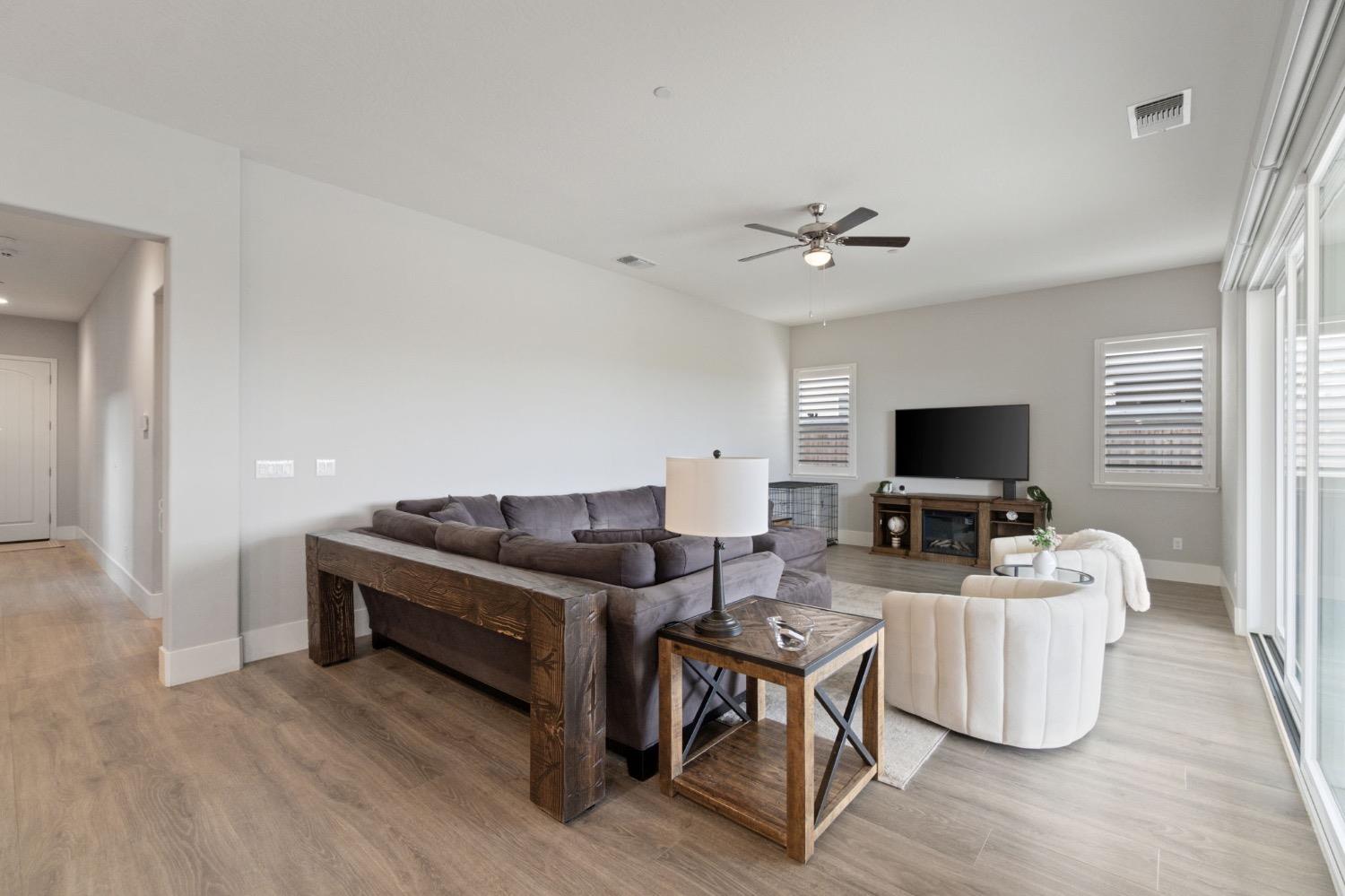 4491 Vineyard Drive Madera, CA 93636 - Photo 7 of 47 a living room with furniture and a flat screen tv